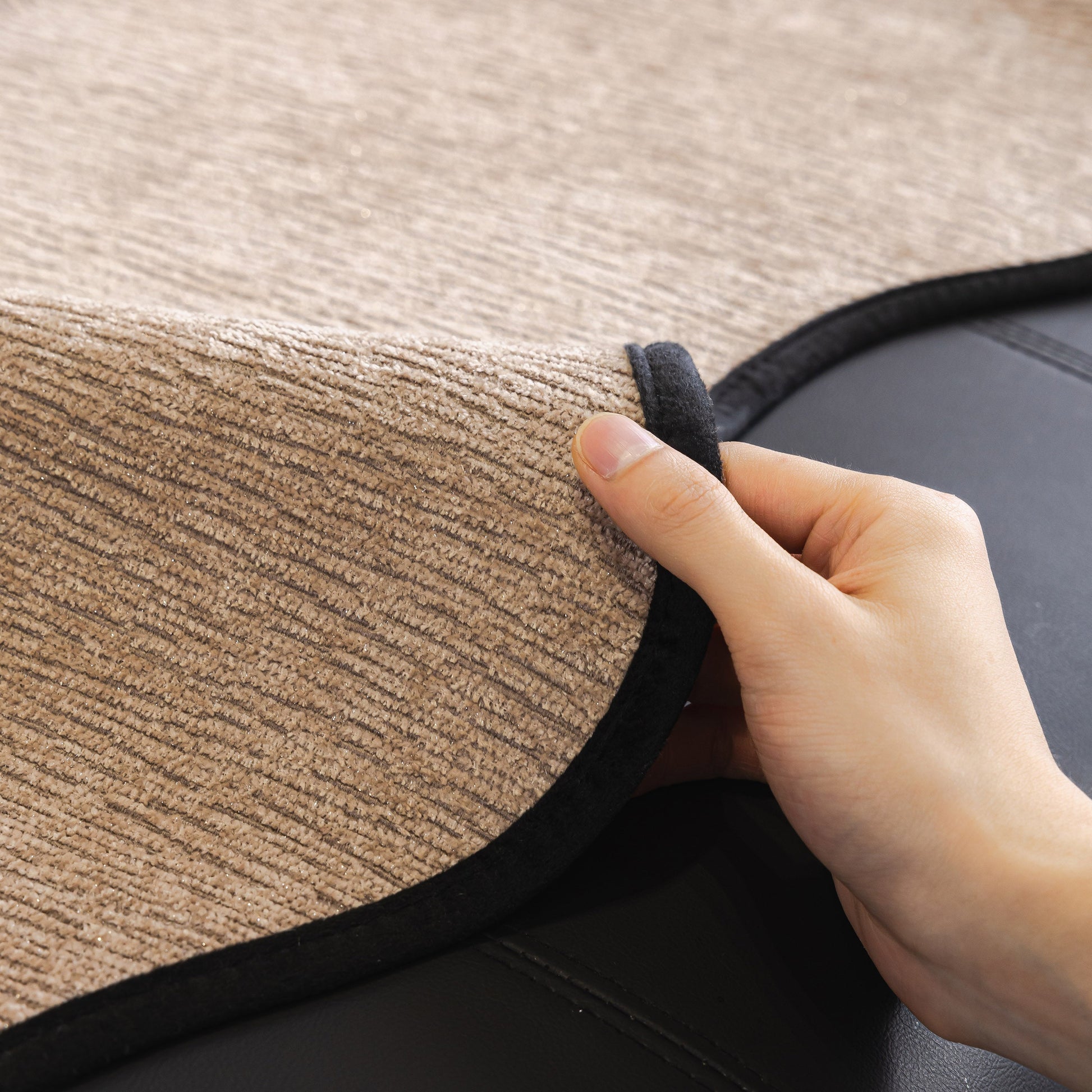 Hand adjusting Chenille Couch Cover with Scalloped Edge, Non-Slip Modular Slipcover Sectional on a sofa