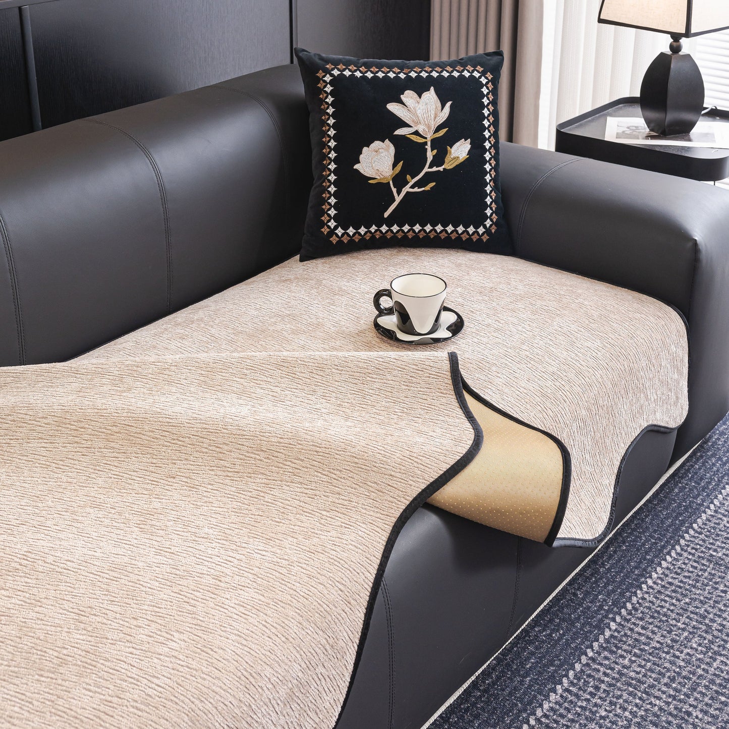 Chenille Couch Cover with Scalloped Edge, Non-Slip Modular Slipcover on black sofa with decorative pillow and coffee cup