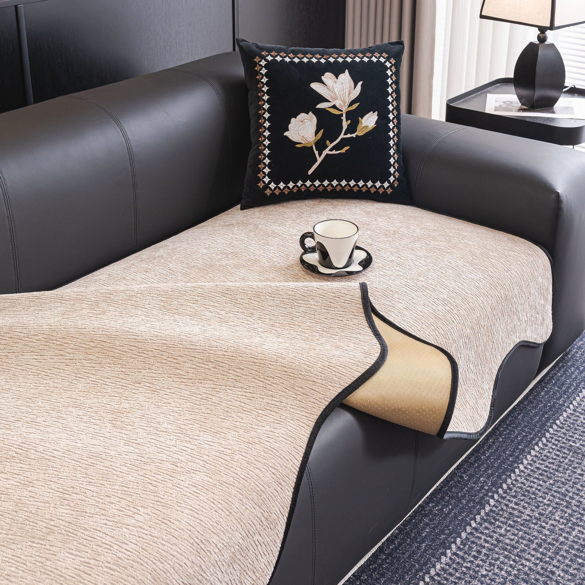 Chenille Couch Cover with Scalloped Edge, Non-Slip Modular Slipcover on black sofa with decorative pillow and coffee cup
