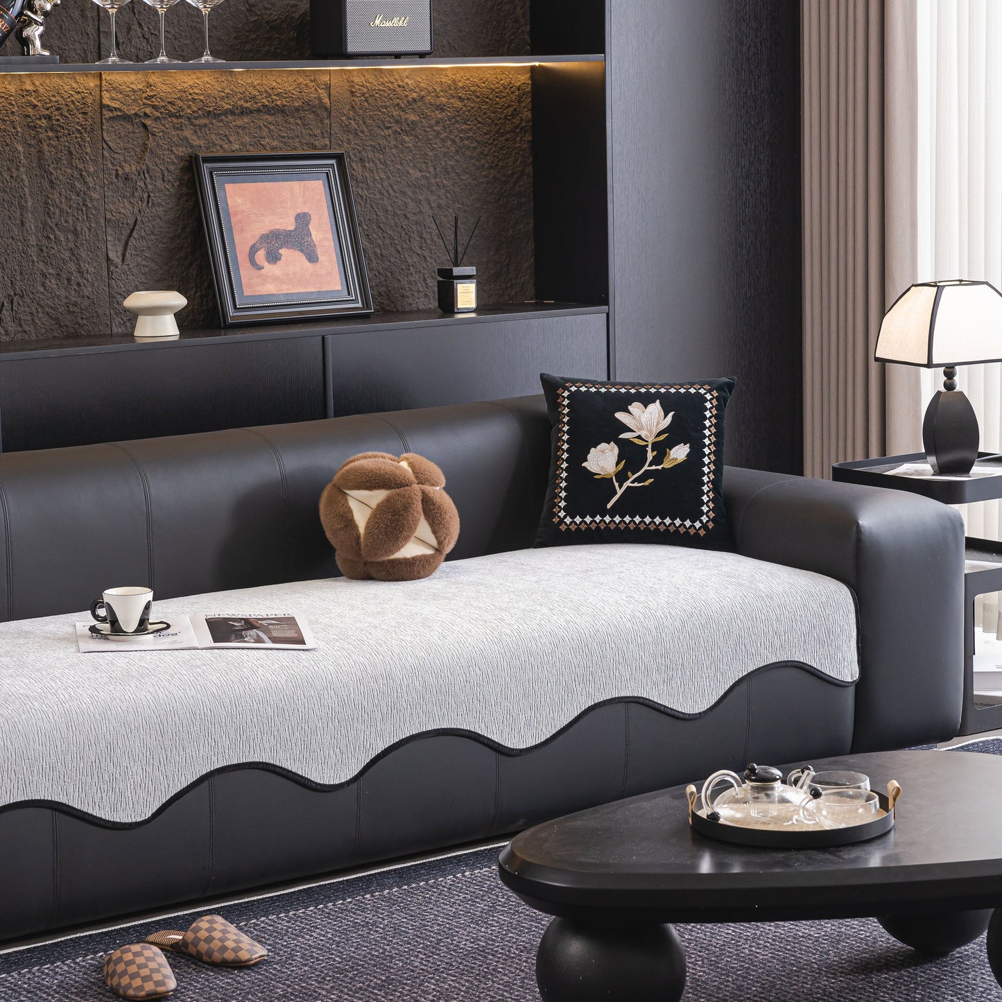 Chenille Couch Cover with Scalloped Edge, Non-Slip Modular Slipcover Sectional on a modern black sofa in stylish living room.