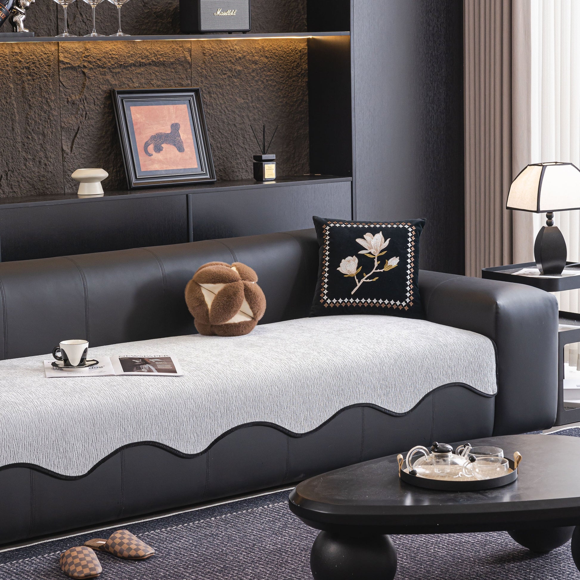 Chenille Couch Cover with Scalloped Edge, Non-Slip Modular Slipcover Sectional on a modern black sofa in stylish living room.