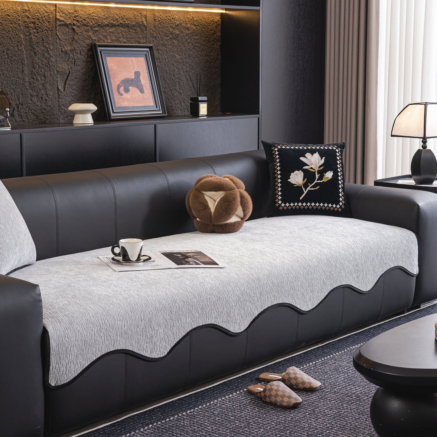 Chenille Couch Cover with Scalloped Edge on modern black leather sofa