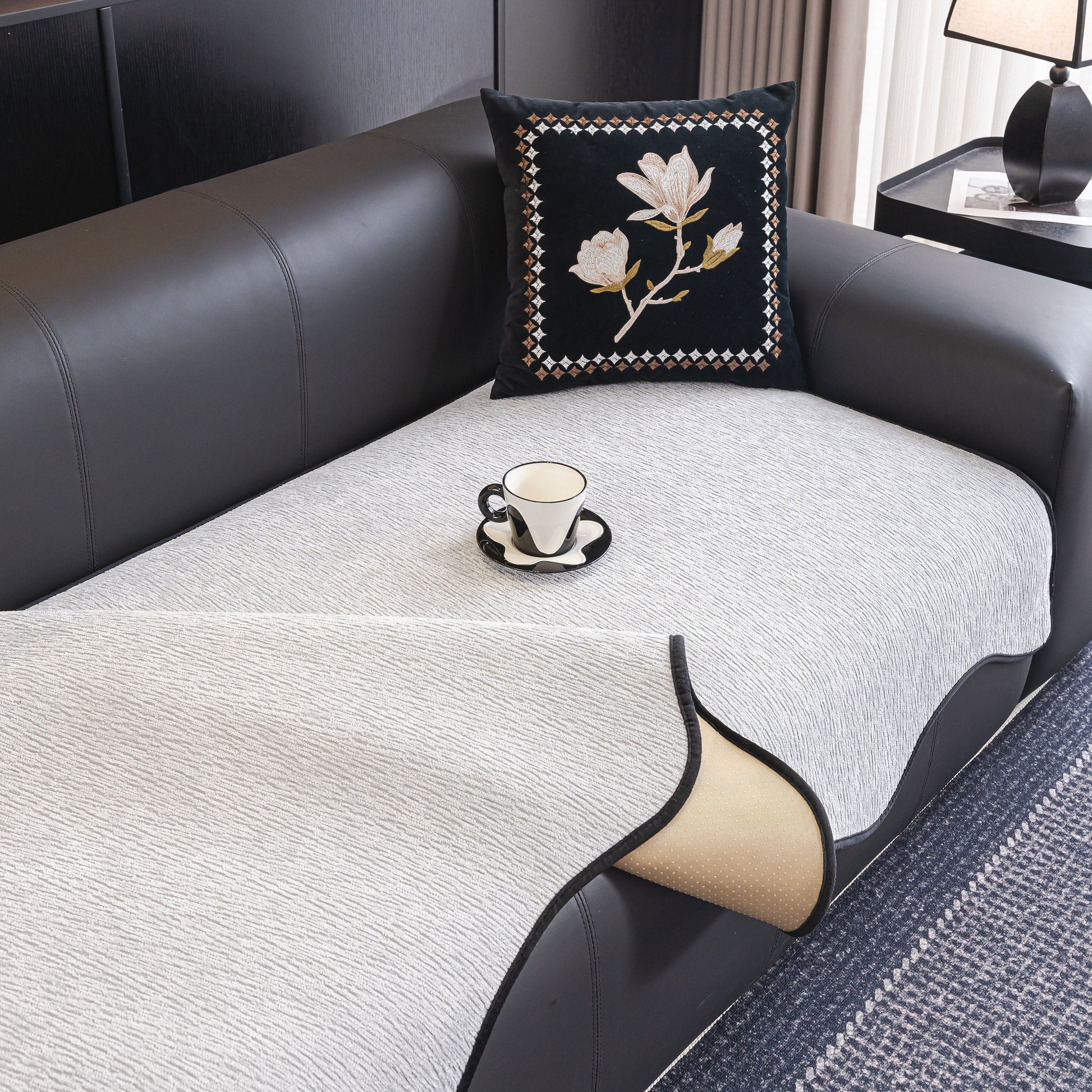 Chenille Couch Cover with Scalloped Edge on leather sofa, featuring non-slip modular slipcover with elegant wave border design.