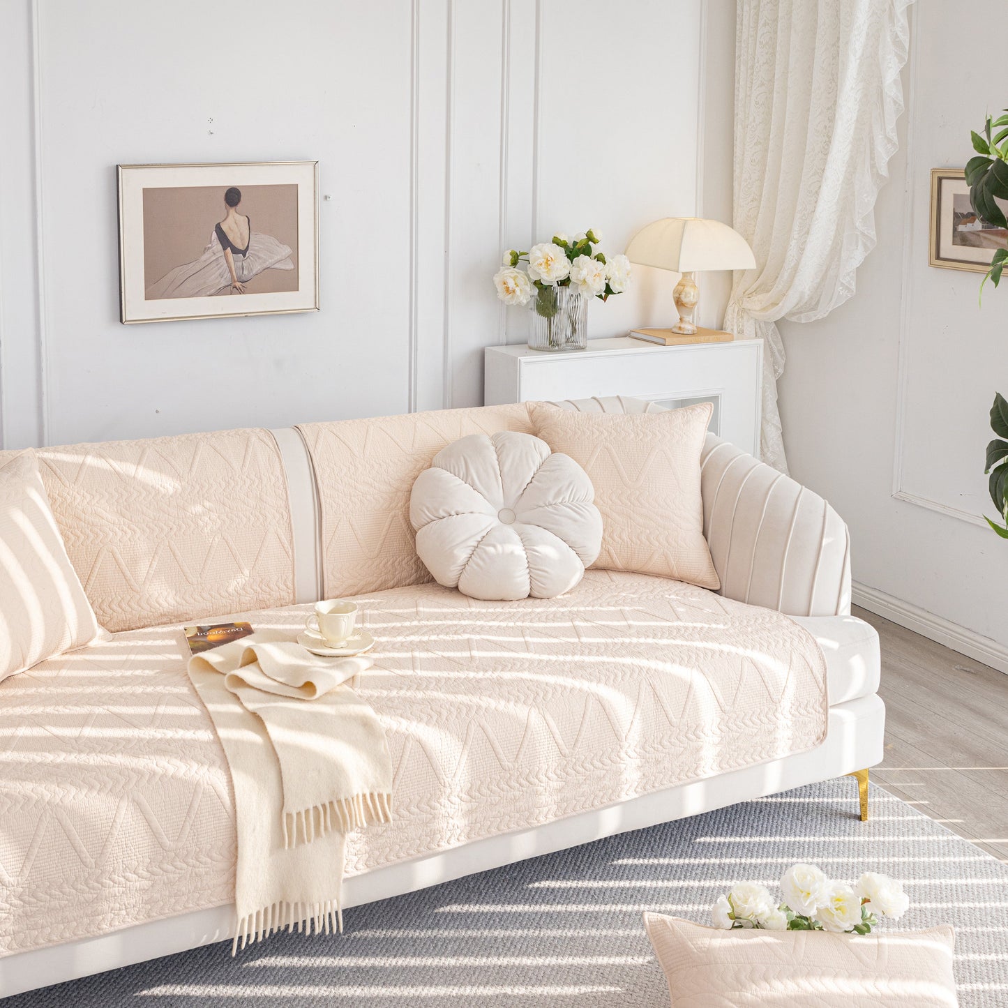 Geometric Textured Cotton Quilted Sofa Cover, Non-Slip Washable Couch Protector on a stylish modern sofa in a bright living room.