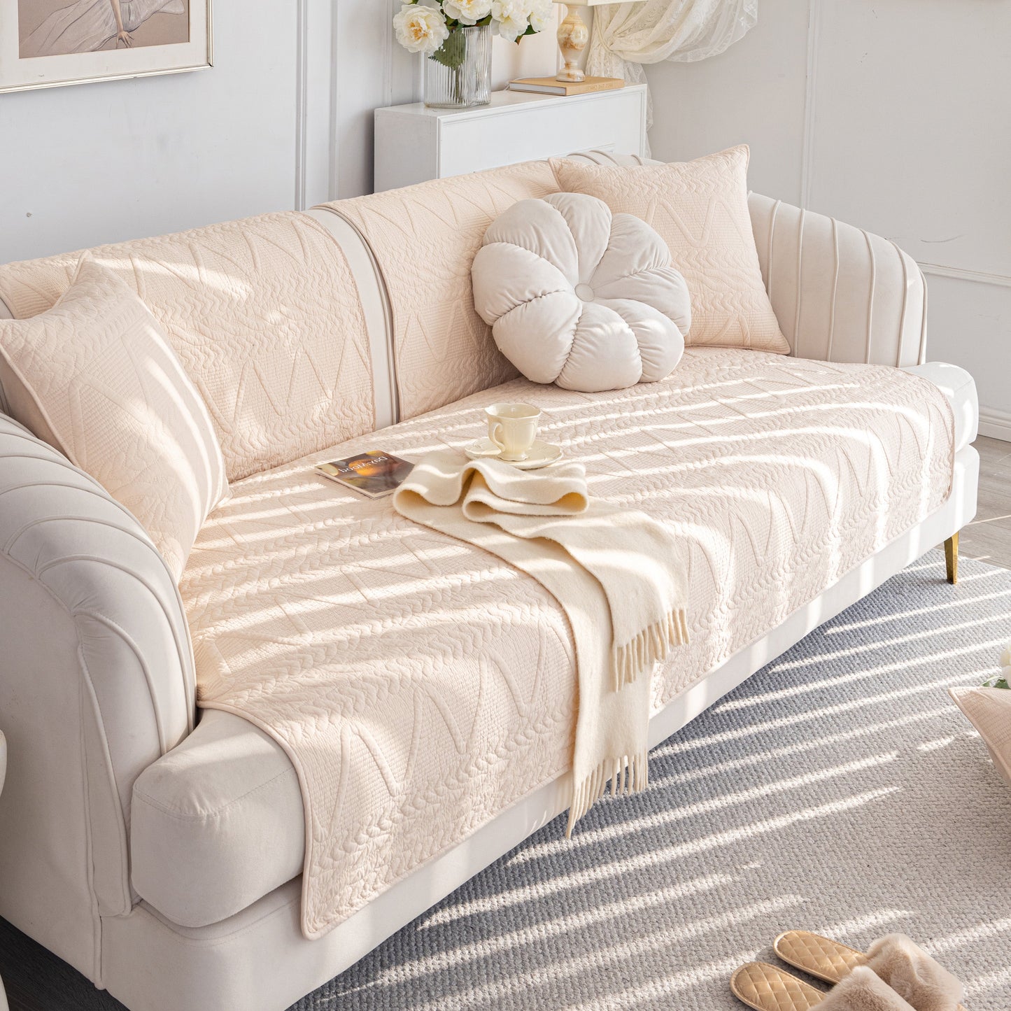 Geometric Textured Cotton Quilted Sofa Cover, Non-Slip Washable Couch Protector on a modern white sofa