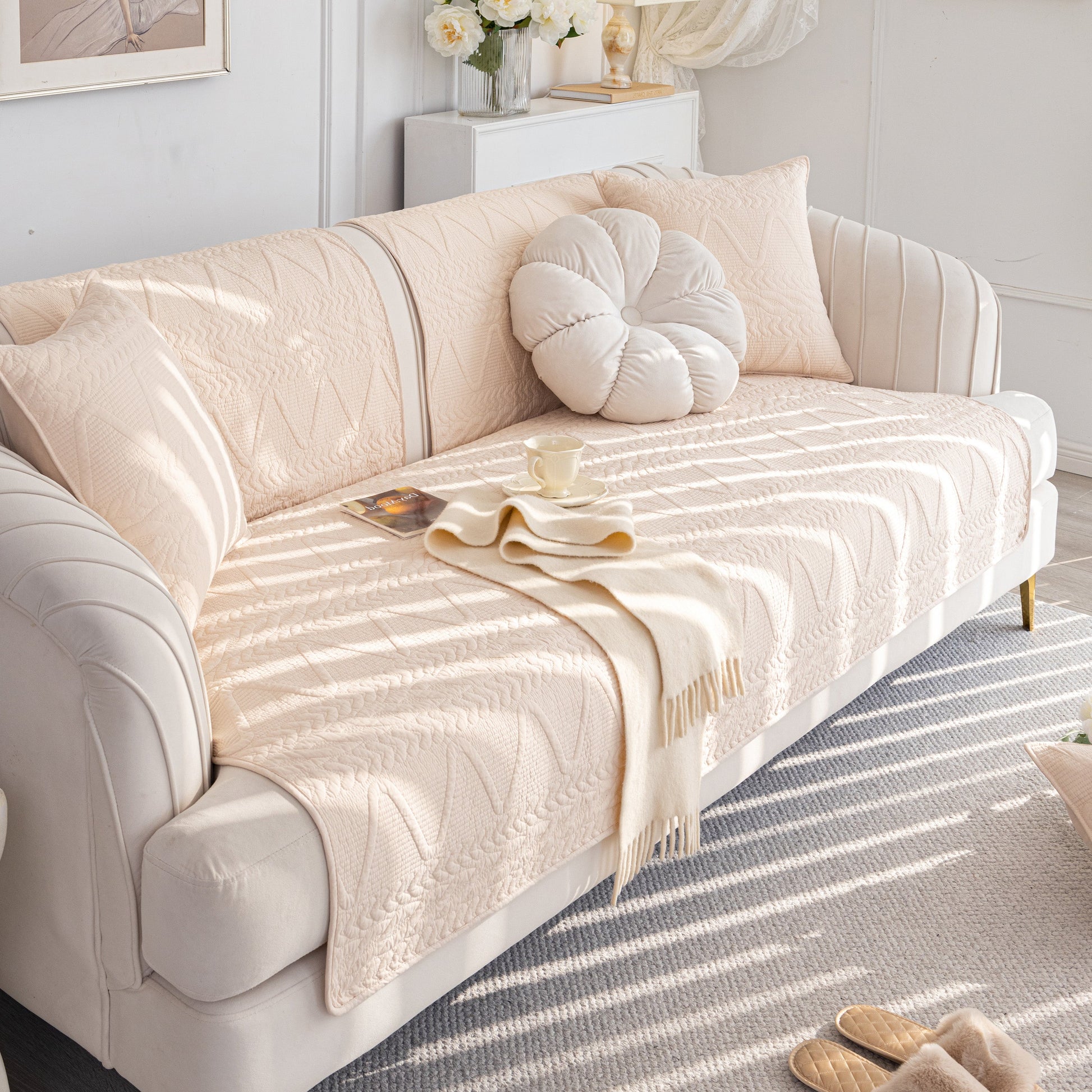 Geometric Textured Cotton Quilted Sofa Cover, Non-Slip Washable Couch Protector on a modern white sofa