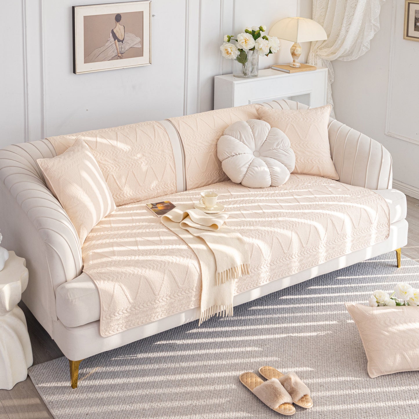 Geometric Textured Cotton Quilted Sofa Cover, Non-Slip Washable Couch Protector on cream-colored living room sofa with pillows.