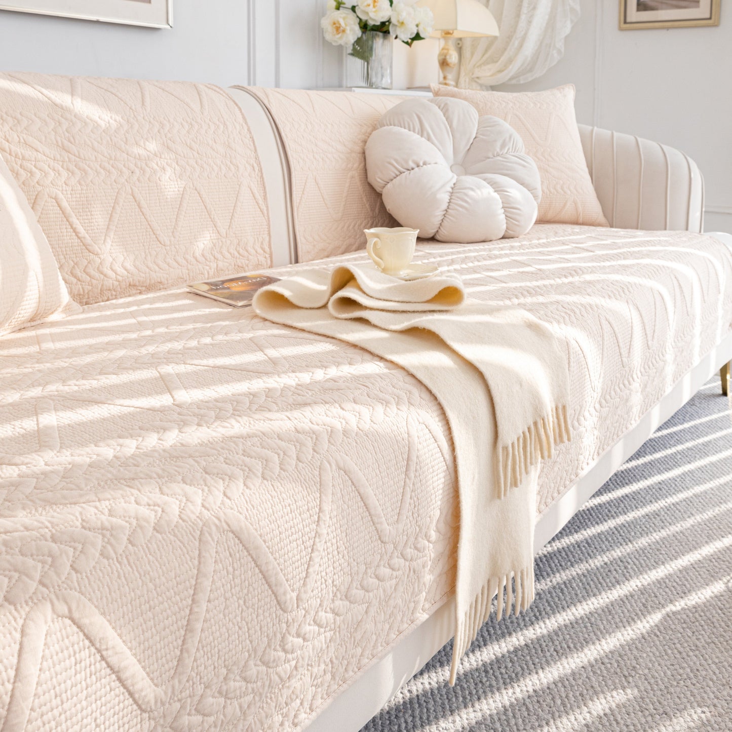 Geometric Textured Cotton Quilted Sofa Cover, Non-Slip Washable Couch Protector on a chic living room sofa with modern design.