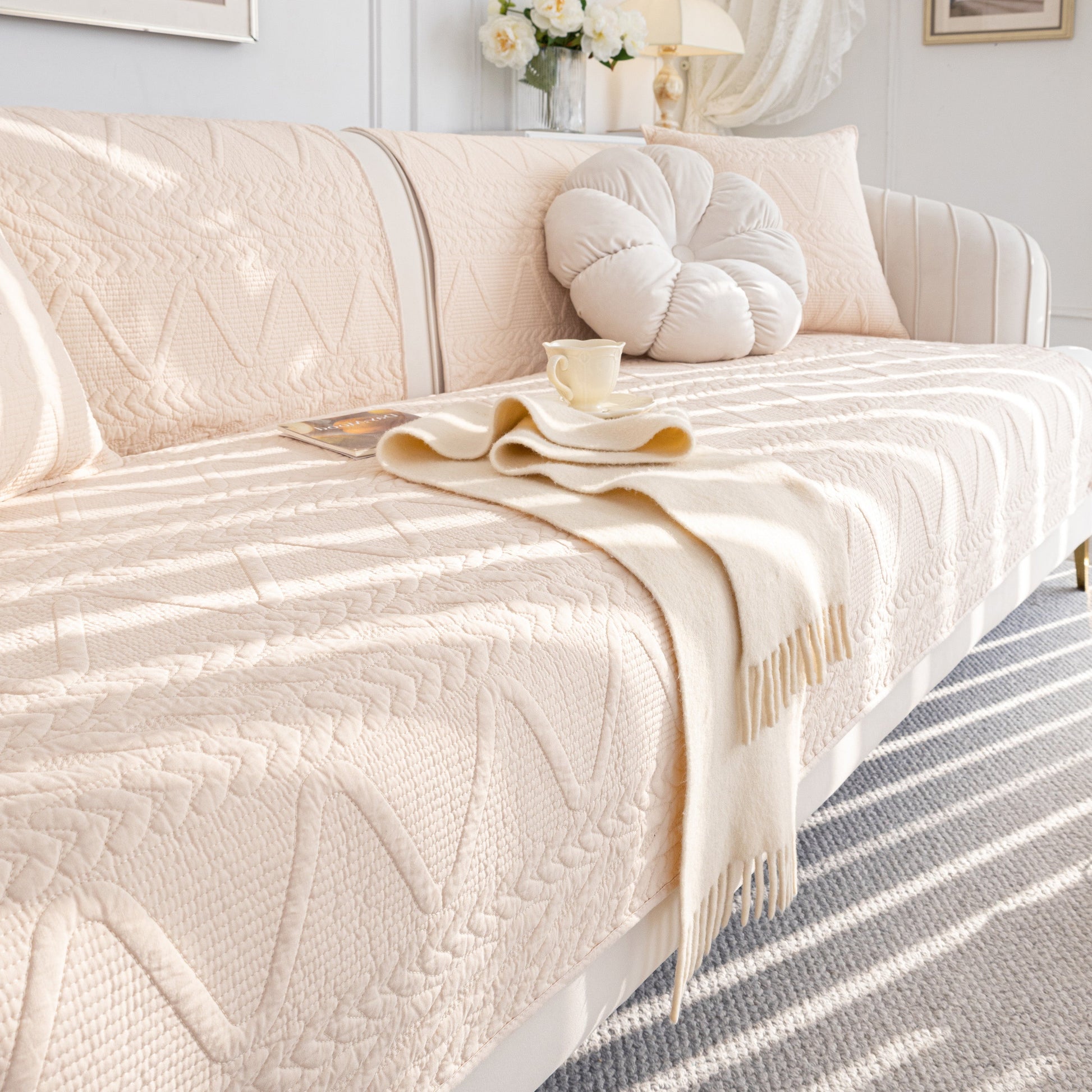 Geometric Textured Cotton Quilted Sofa Cover, Non-Slip Washable Couch Protector on a chic living room sofa with modern design.