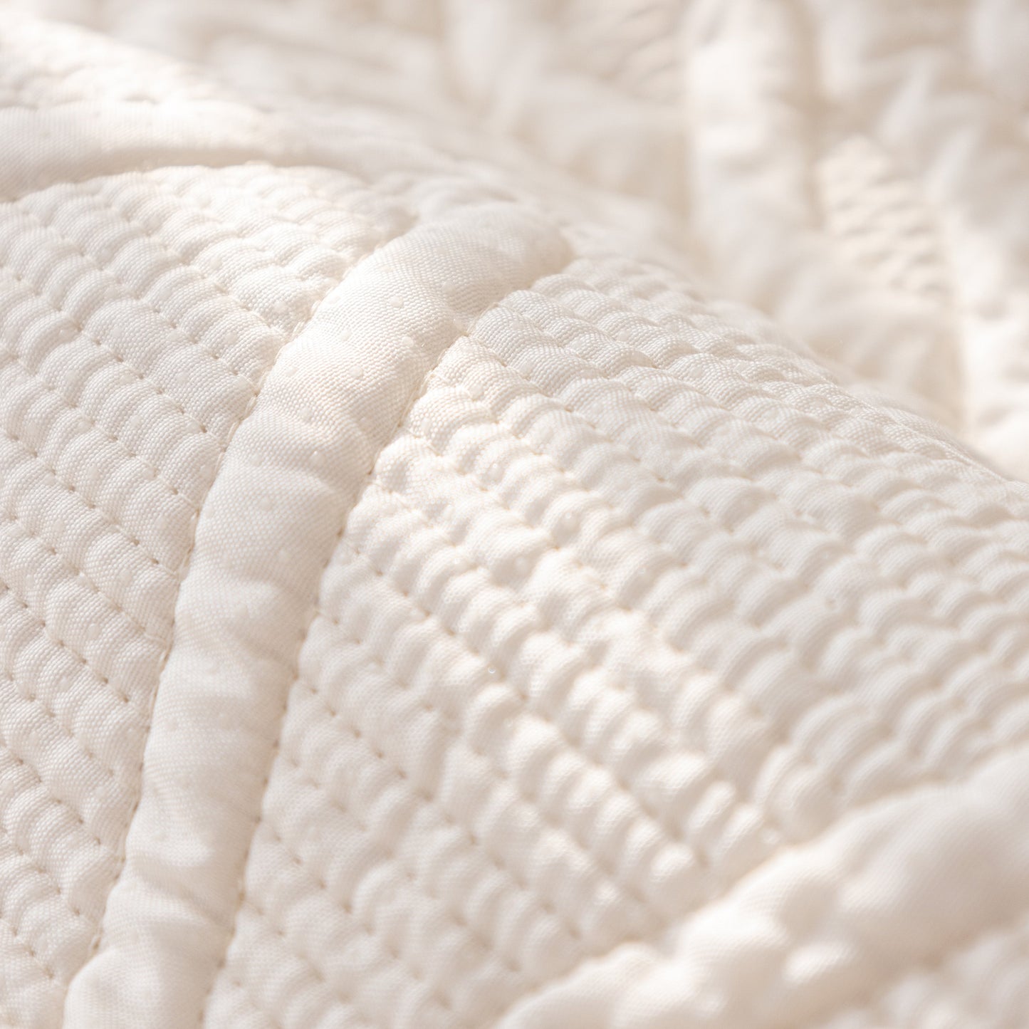 Close-up of Geometric Textured Cotton Quilted Sofa Cover, Non-Slip Washable Couch Protector with intricate stitching.