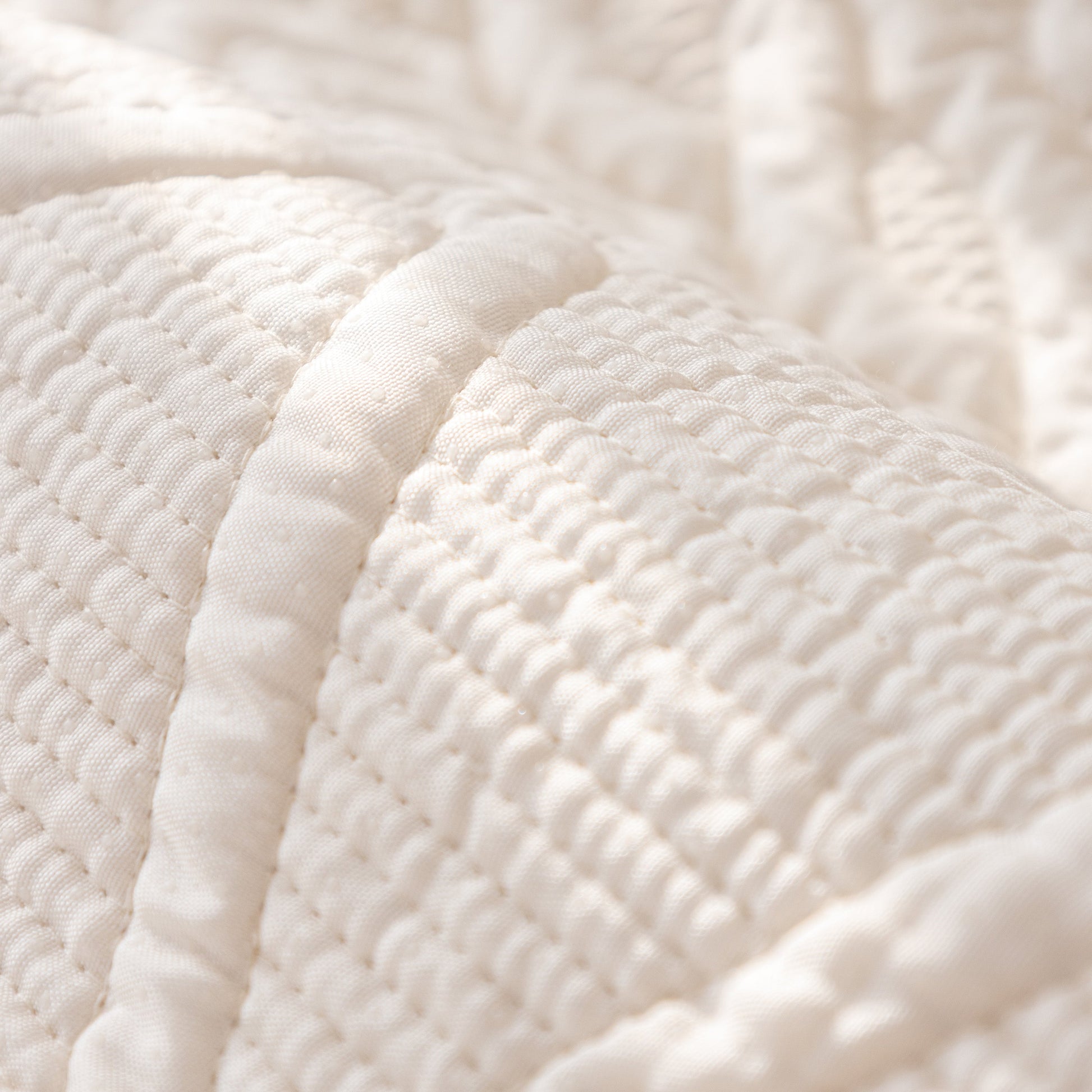 Close-up of Geometric Textured Cotton Quilted Sofa Cover, Non-Slip Washable Couch Protector with intricate stitching.
