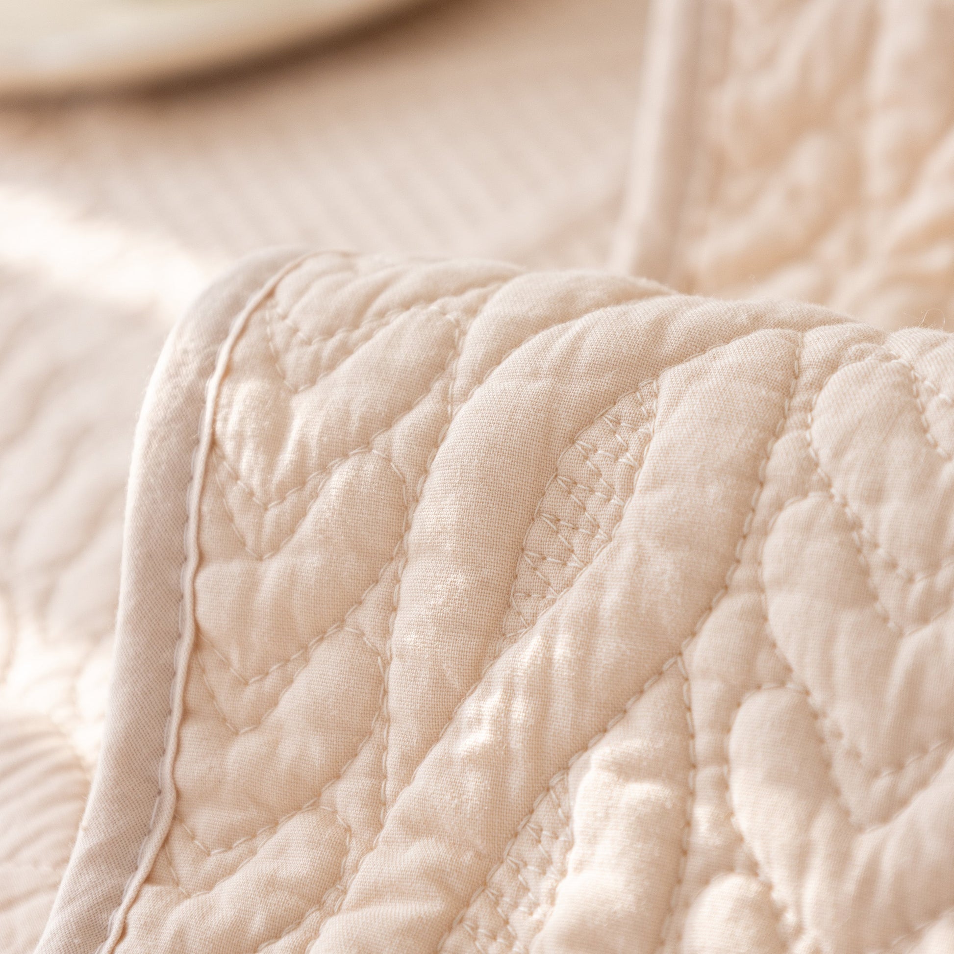Geometric Textured Cotton Quilted Sofa Cover, Non-Slip Washable Couch Protector with intricate stitched V-shaped patterns.