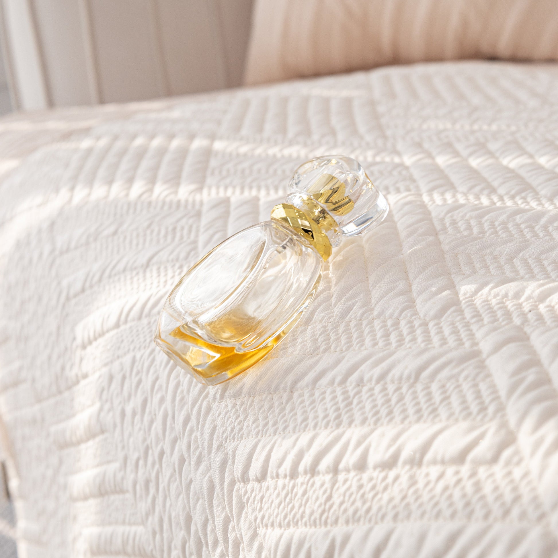 Quilted Geometric Cotton Sofa Cover, Non-Slip & Thick Padded Furniture Covers shown with perfume bottle on top.