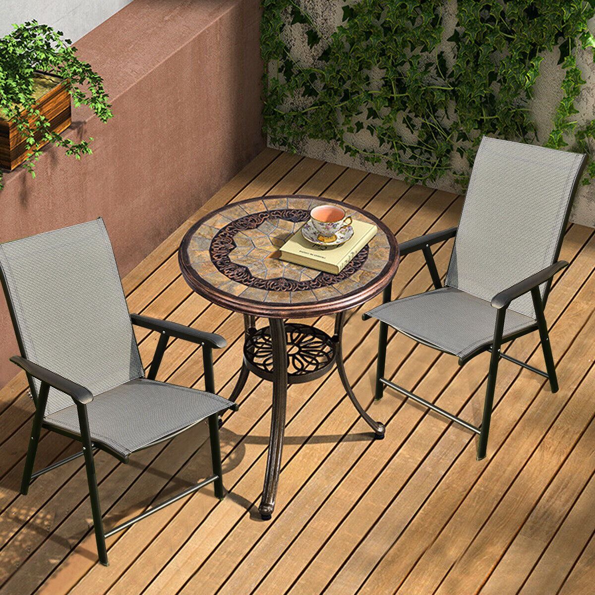 Set of 2 Outdoor Patio Folding Chairs-Gray with ergonomic armrests and sturdy steel frame on wooden deck beside a decorative table.