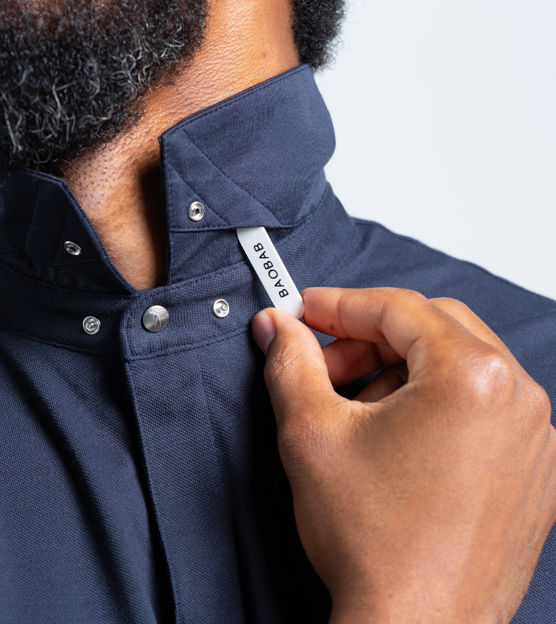Short Sleeve Perfect Polo with StaySharp™ Collar being adjusted, highlighting modern style and innovation.