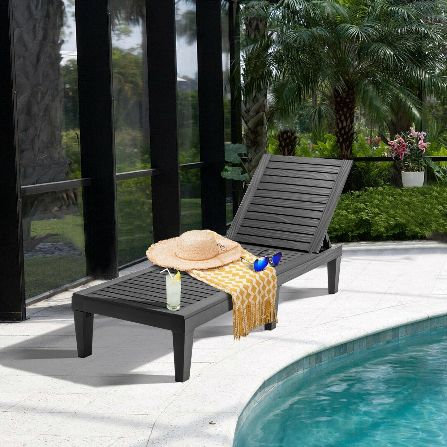 Outdoor Recliner Chair with 5-Position Adjustable Backrest-Black by a poolside surrounded by lush greenery.
