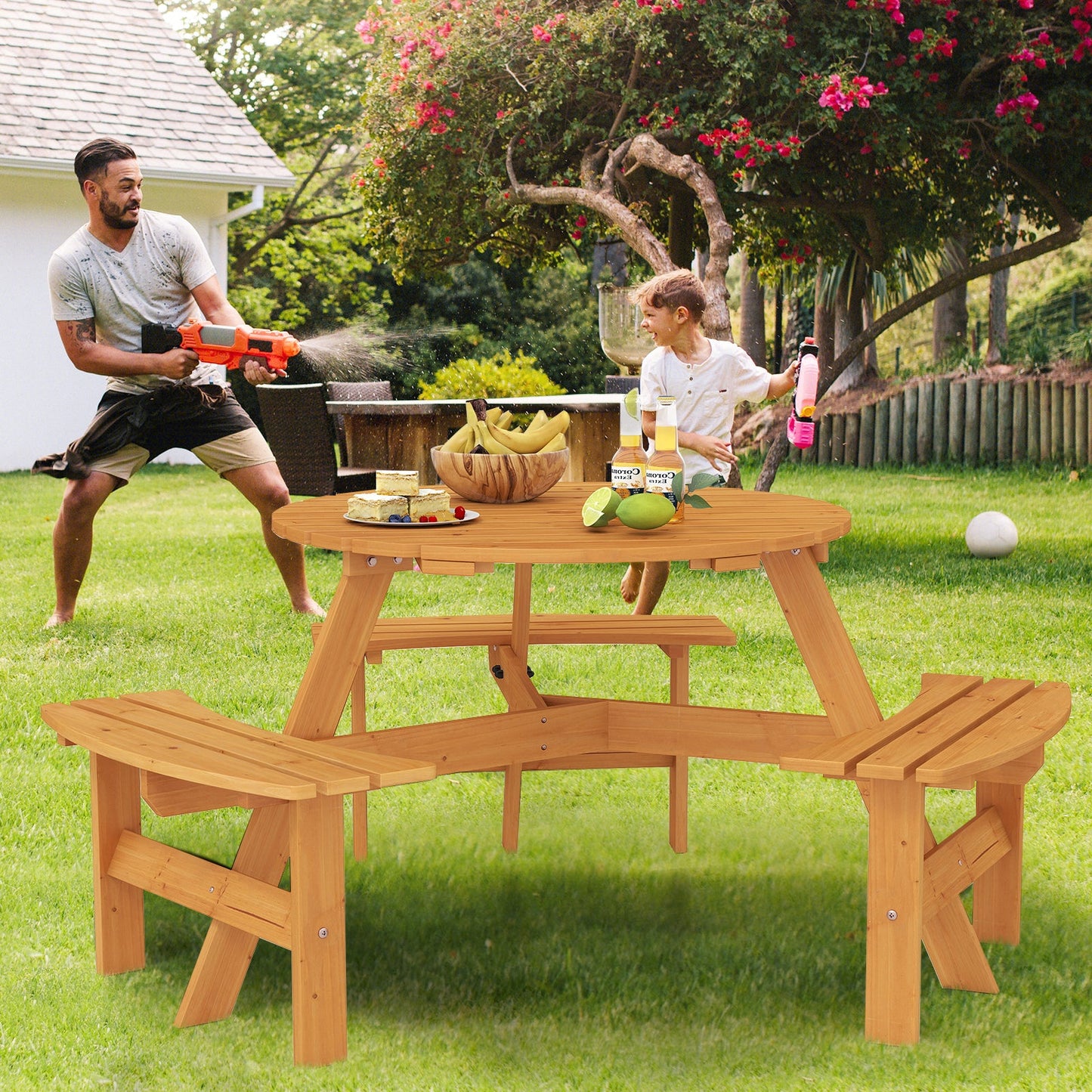 6-Person Round Picnic Table Set with 3 Built-in Benches and Umbrella Hole-Yellow in a garden with people playing around it