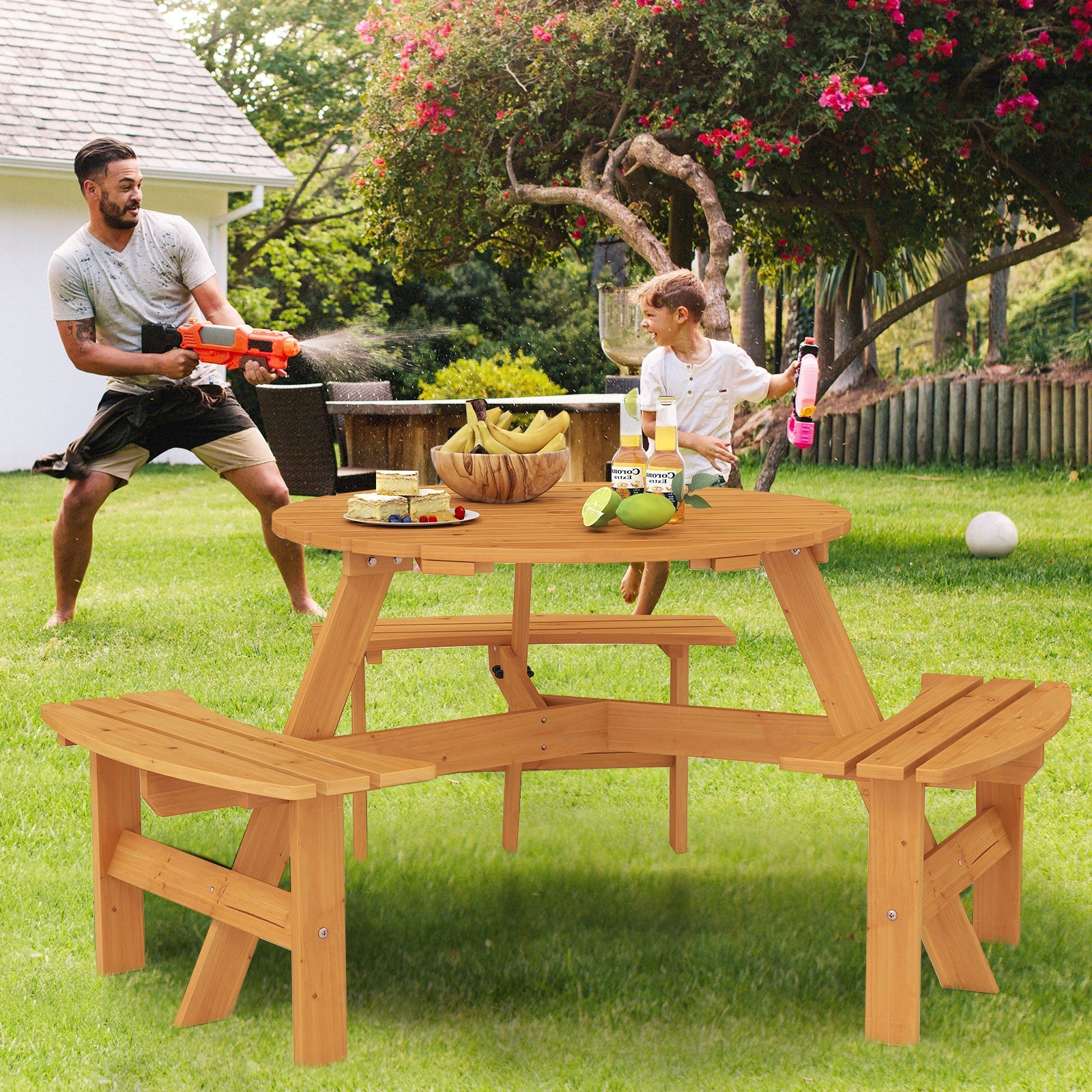 6-Person Round Picnic Table Set with 3 Built-in Benches and Umbrella Hole-Yellow in a garden with people playing around it