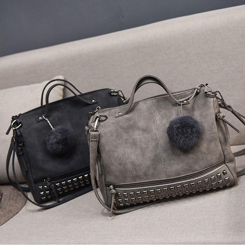 Rustic Charm Leather Shoulder Bag – Stylish Cowgirl Handbag with simulated leather and rivet details in black and grey with pom-poms