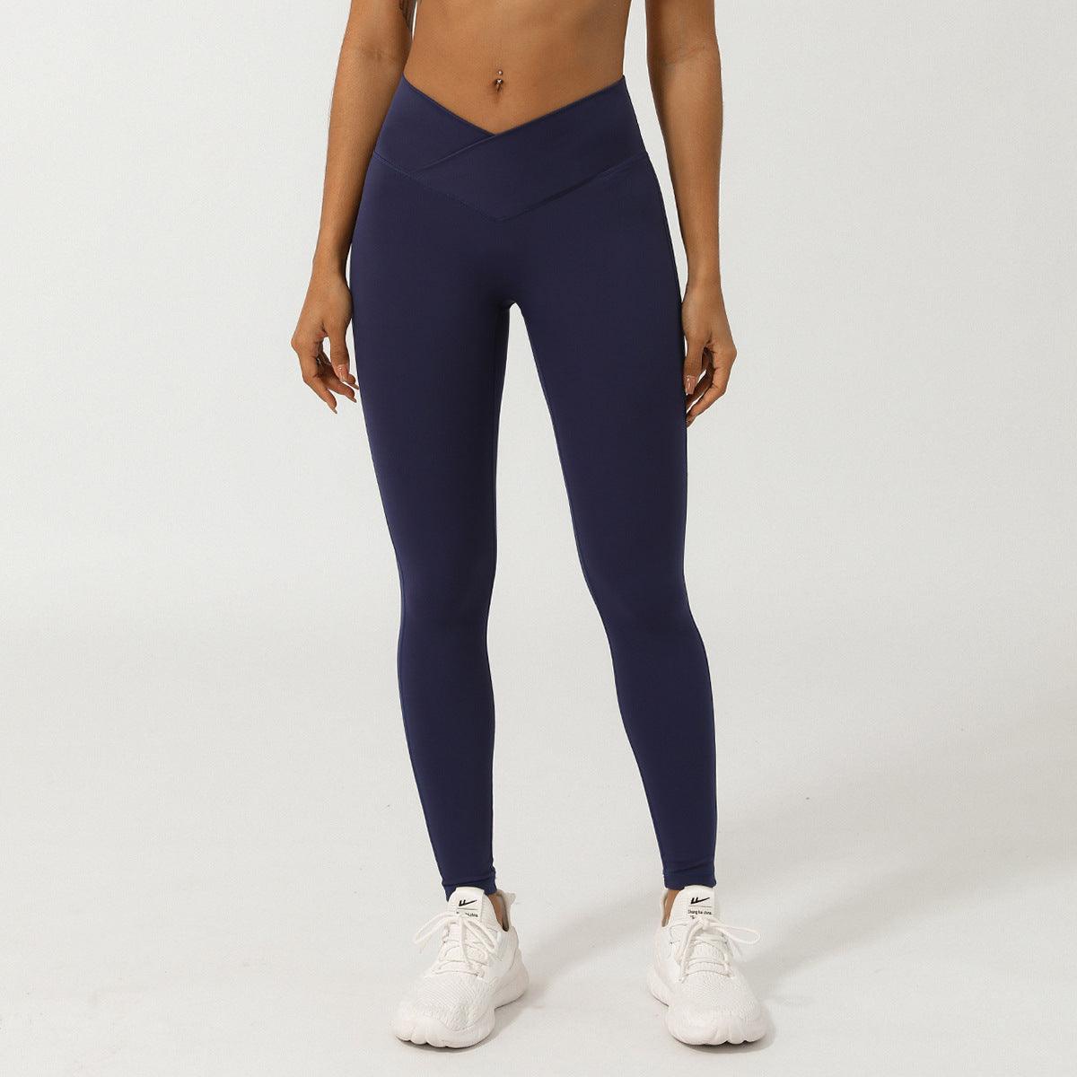 Woman wearing V-Shaped High-Waisted Yoga Pants | Skinny Fit Workout Pants for Fitness & Yoga in navy blue, front view.
