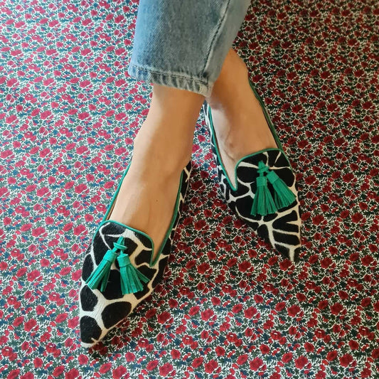 Cow Print Tassel Pumps Women | Casual Slip-On Style on floral background