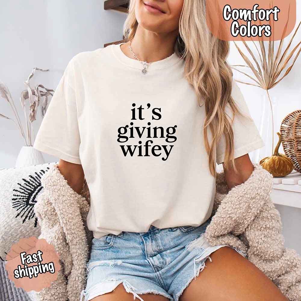 Woman wearing It's Giving Wifey Comfort Colors Tee, perfect for brides. Fast shipping available. Casual bridal vibes with cozy style.