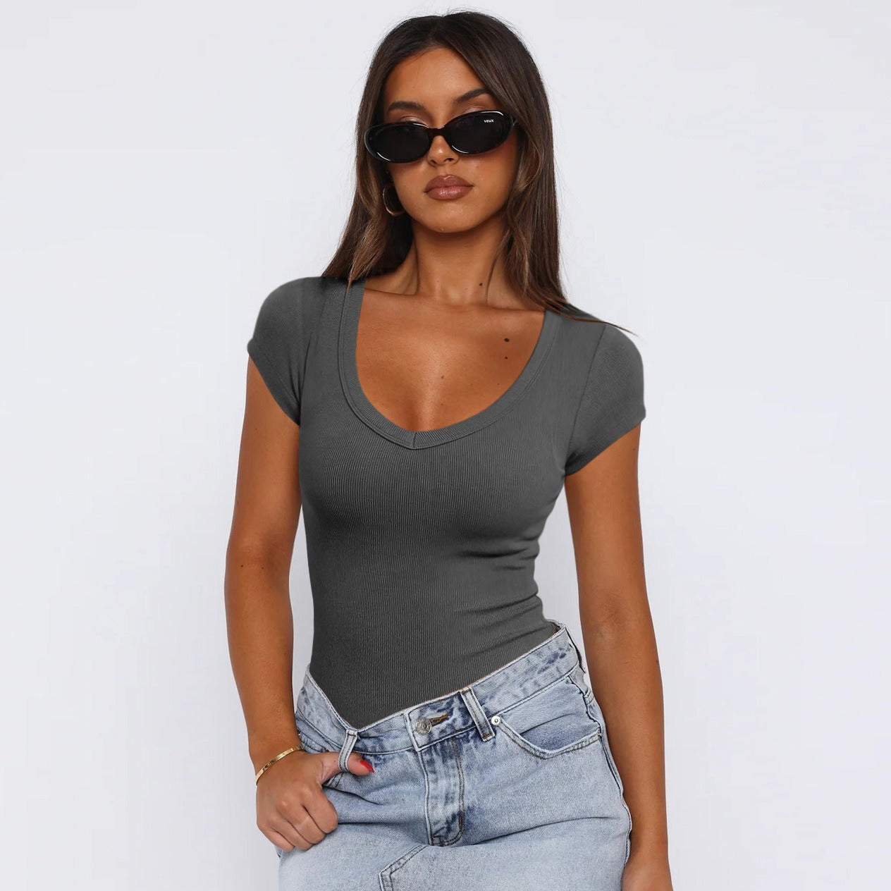 Model wearing Saddle Ridge Everyday Tee in Deep Grey, stylish short sleeve tee for modern cowgirls, paired with denim jeans, front view.