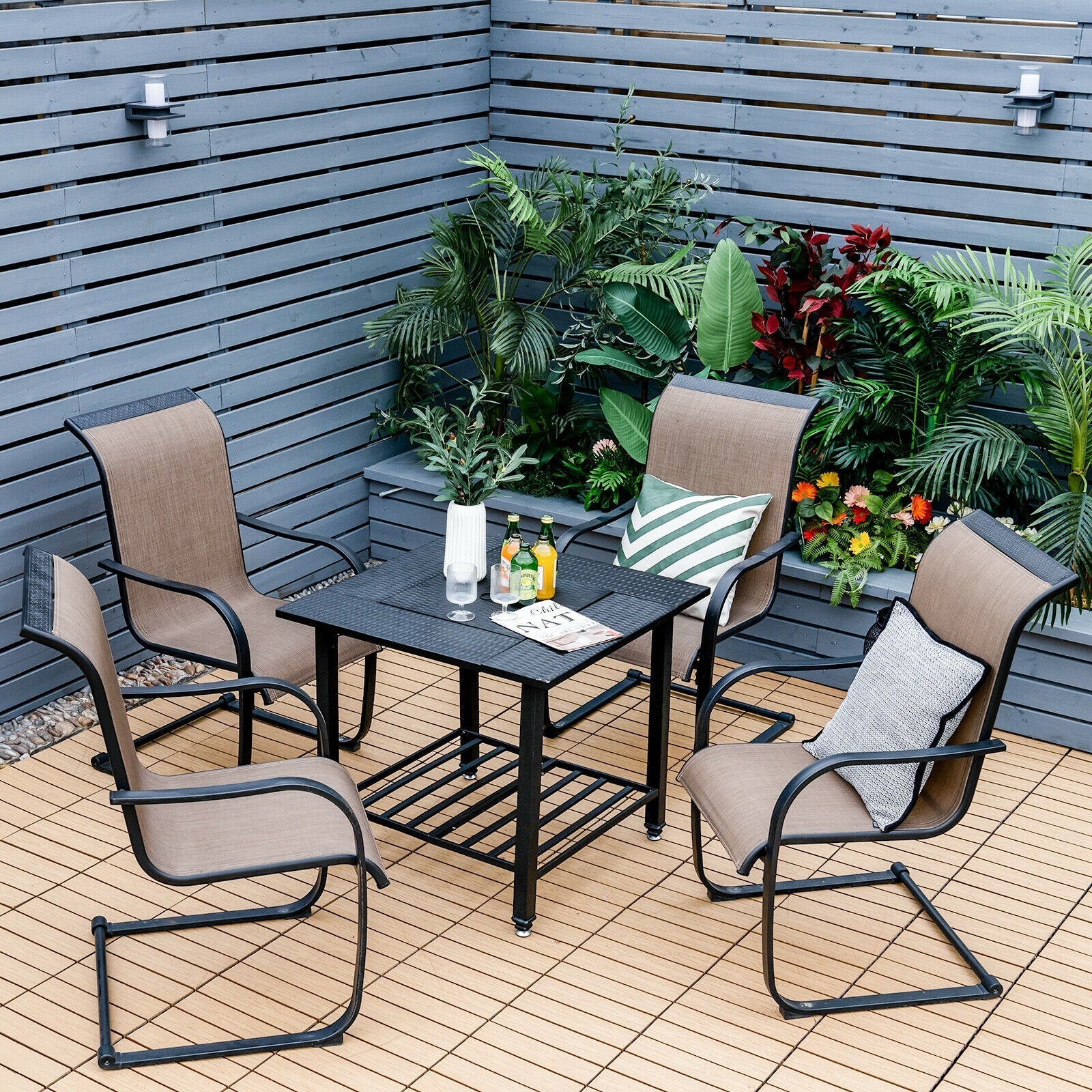 31 Inch Outdoor Fire Pit Dining Table with Cooking BBQ Grate surrounded by chairs in a lush outdoor setting.