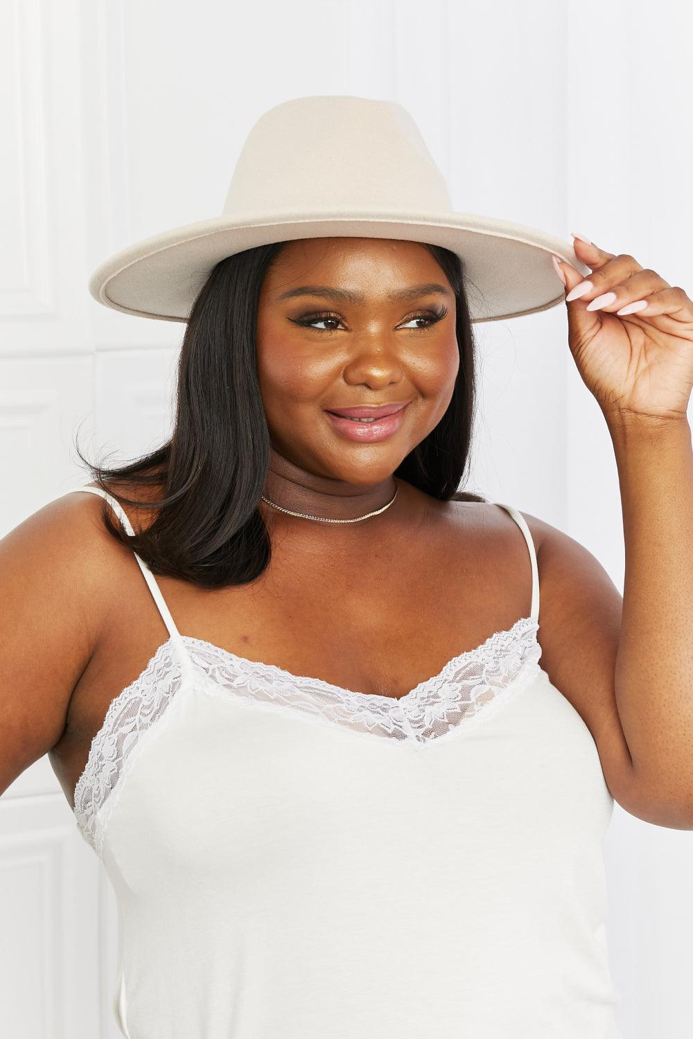 Savannah Sunset Hat - Woman wearing beige fedora with black faux leather belt and gold hardware in a stylish outfit