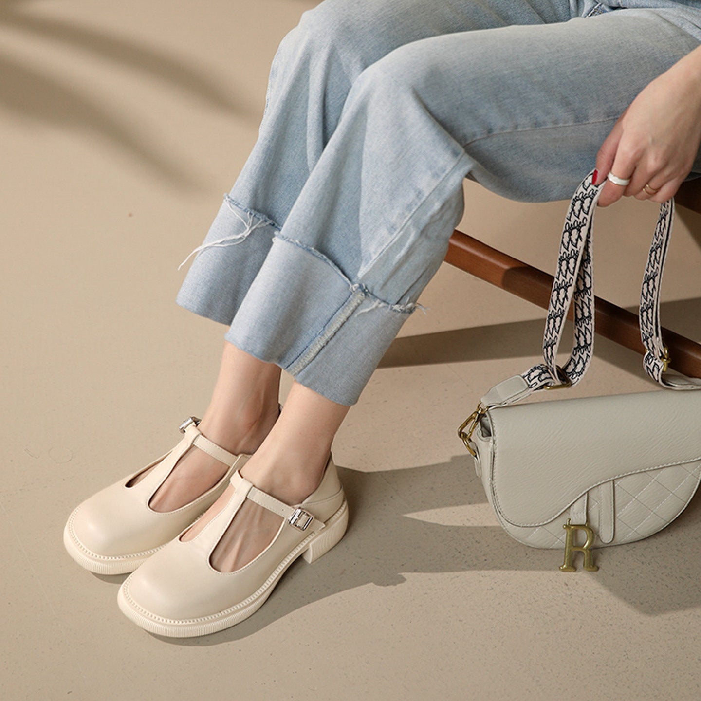 Woman wearing milky white Women’s Shallow-Mouth Mary Jane Shoes with flat heel and buckle detail, perfect for vintage warm-season style.