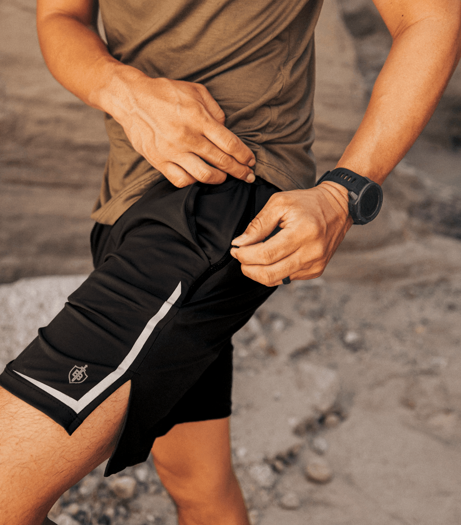 Close up of Dominate Training Shorts Black double zip pocket and reflective detail