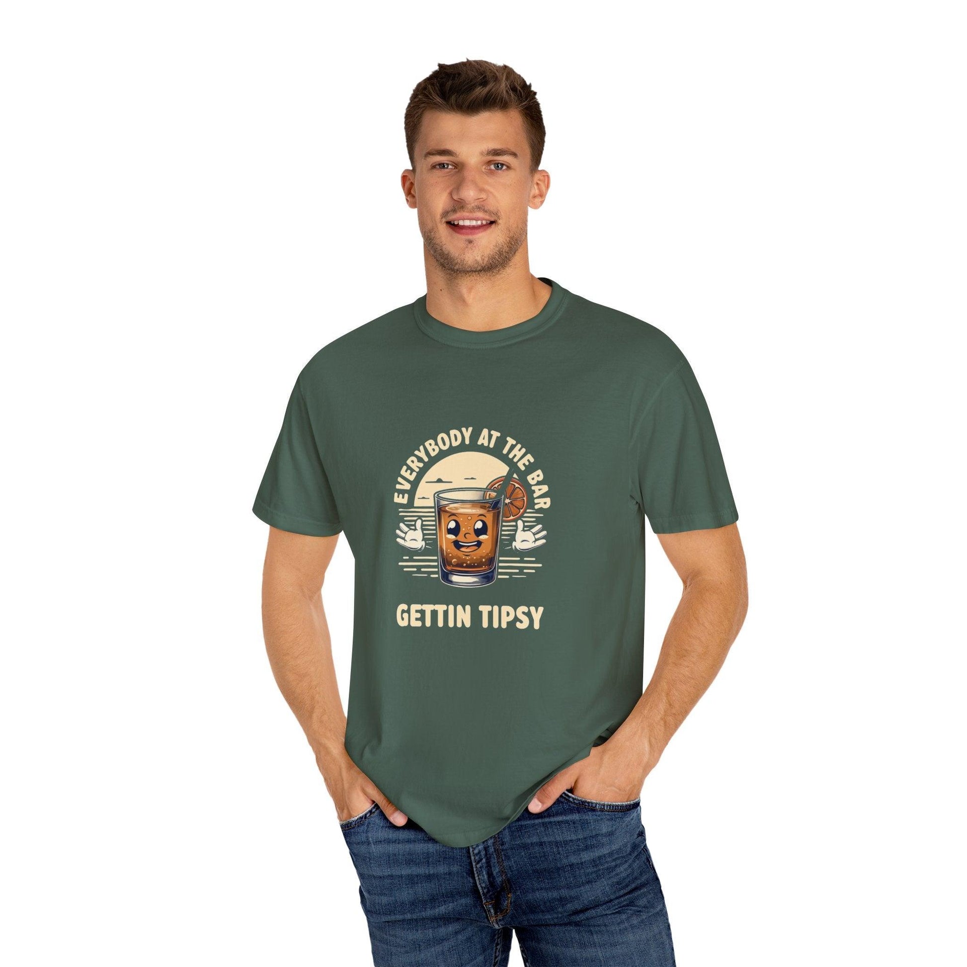 Man wearing Everybody at the Bar Gettin Tipsy Unisex Garment-Dyed T-Shirt with whiskey glass graphic and playful text.