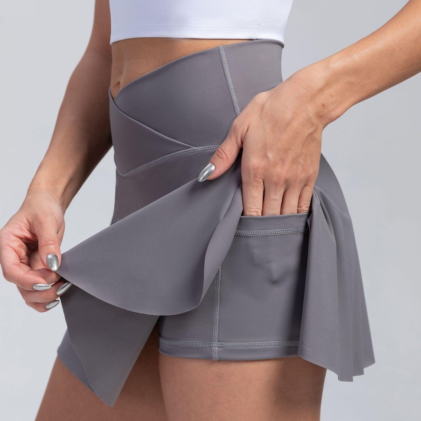 Close-up of Cowgirl Fit High-Waisted Yoga Skirt Shorts in gray, showing sporty, stylish, and comfortable activewear design with skirt overlay.