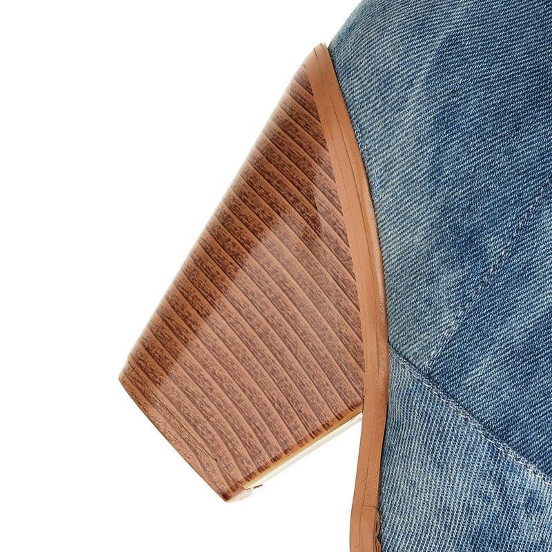 Close-up of heel on Tie Dye Denim Knee-High Cowgirl Boots with wood grain texture