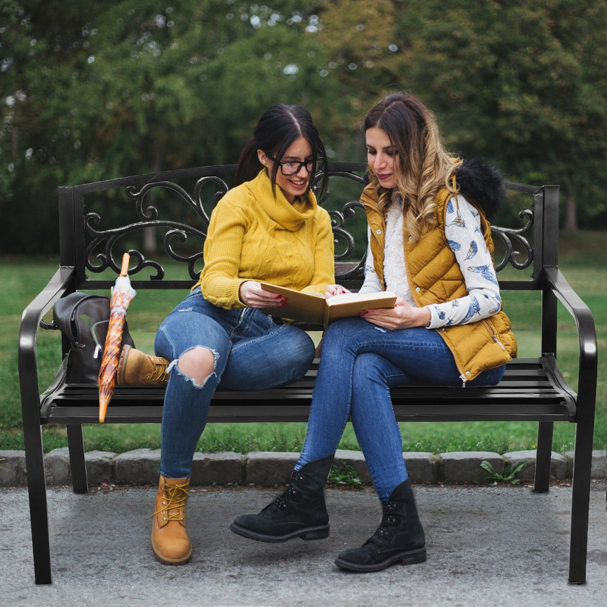 Two people sitting on a 50 Inch Patio Park Steel Frame Cast Iron Backrest Bench Porch Chair in a park.