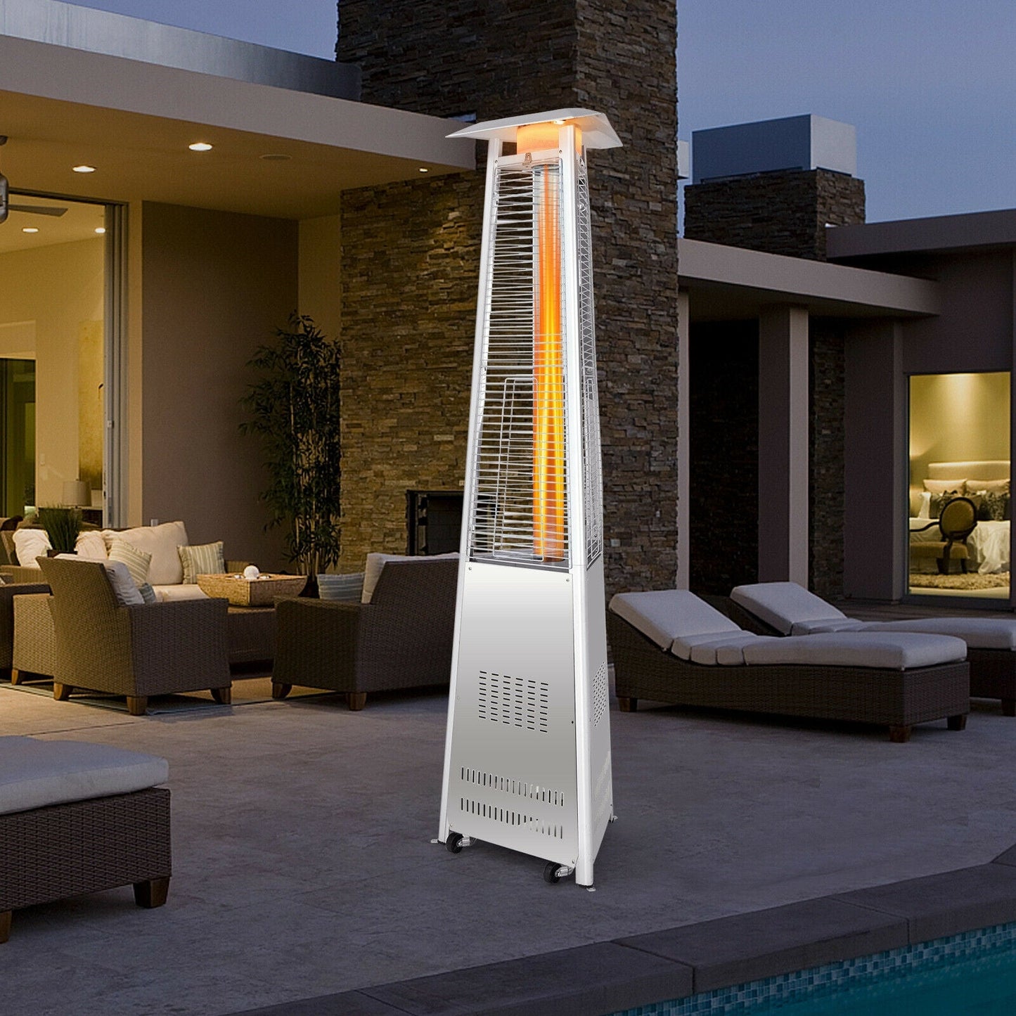 42 000 BTU Stainless Steel Pyramid Patio Heater With Wheels in outdoor setting at dusk