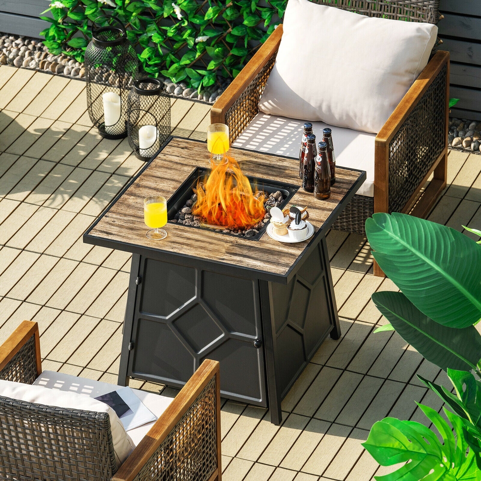 Outdoor setup featuring a 40 000 BTU 28 Inches Propane Gas Fire Pit Table With Cover, surrounded by chairs and greenery.