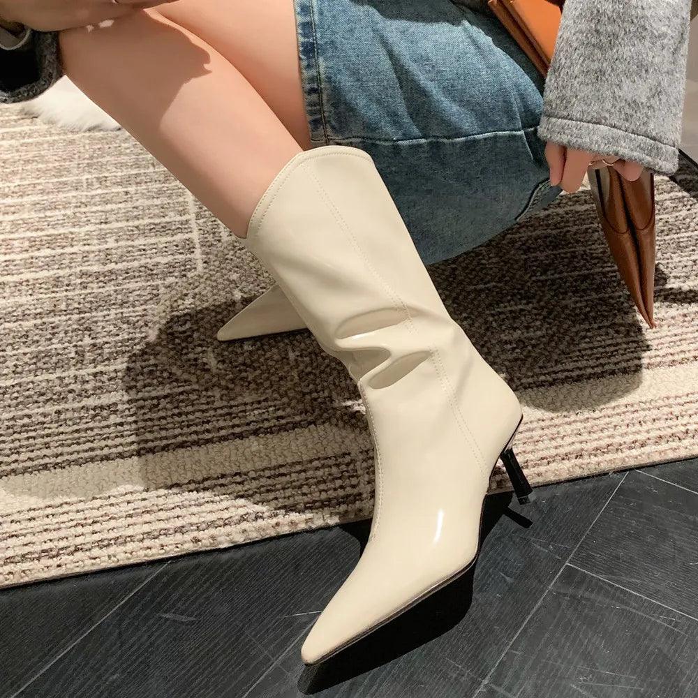 Woman wearing off-white Elegant Stiletto Mid-Calf Boots on beige patterned carpet