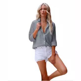 Woman wearing Summer Breeze Button-Up Shirt – Stylish Cotton and Linen Top for Women with white shorts, showcasing relaxed fit and comfort.