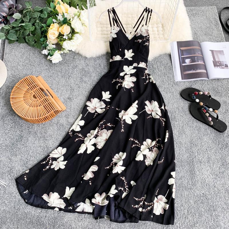 Floral maxi dress with strappy neckline and flowy skirt displayed with bamboo handbag and floral sandals on gray carpet, perfect for spring
