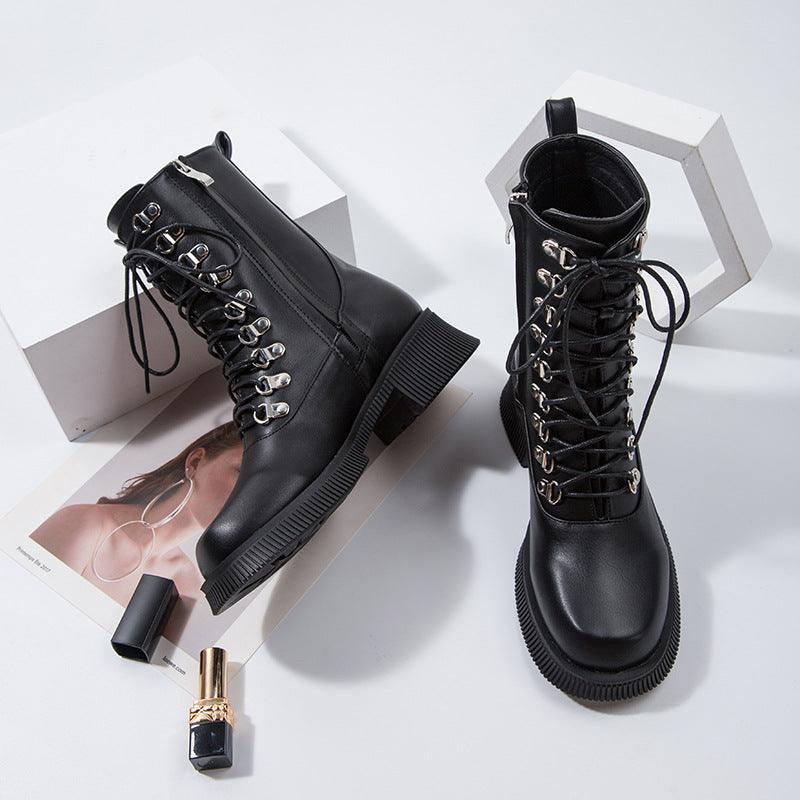 Black Knight Lace-Up Boots - black mid-calf boots with silver eyelets and thick soles on display.
