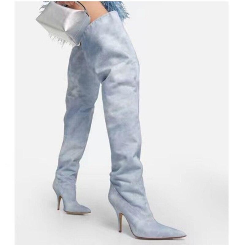 Woman wearing Women's Ultra-High Heel Denim Pointed Toe Catwalk Knee Boots styled with a silver handbag.