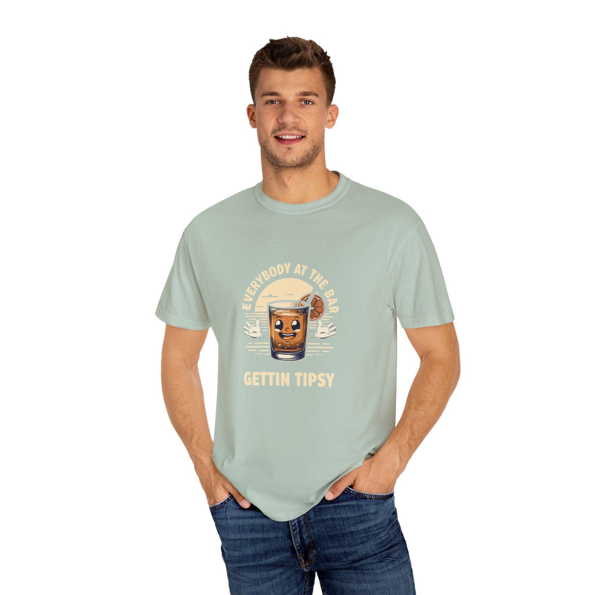 Man wearing Everybody at the Bar Gettin Tipsy Unisex Garment-Dyed T-Shirt with whiskey graphic and playful text.