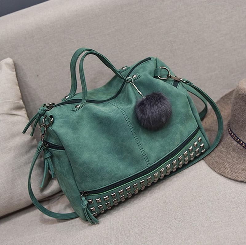 Rustic Charm Leather Shoulder Bag – Stylish Cowgirl Handbag with rivet details and soft structure on a couch.