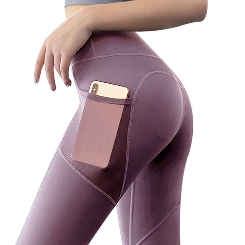 Woman wearing purple Yoga Leggings with Phone Pocket, featuring mesh details and a phone pocket on the side.