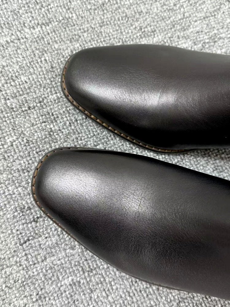 Top view of Women’s Retro Square-Toe Mid-Heel Chunky Leather Boots in matte finish, showcasing the classic square-toe design on a textured surface.