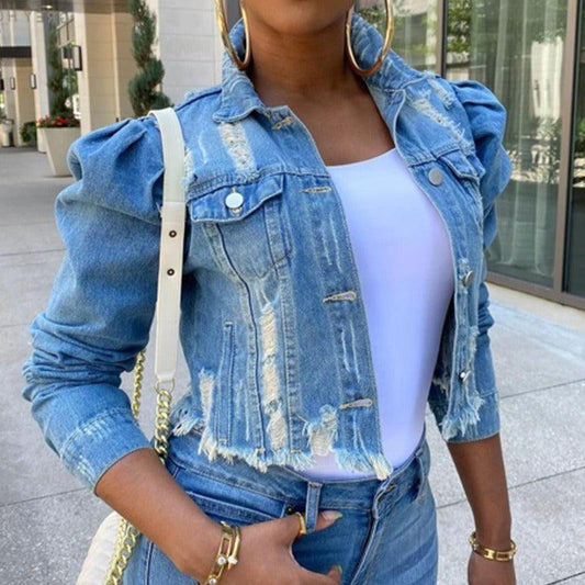 Woman wearing Chic Distressed Denim Puffy Sleeves Jacket – Fashionable Cropped Jean Jacket with puffy sleeves and distressed detailing.