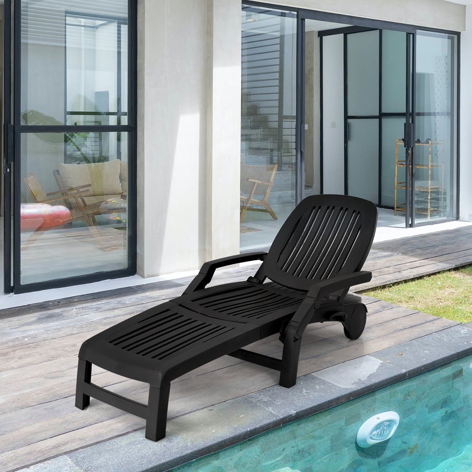 Adjustable Patio Sun Lounger with Weather Resistant Wheels-Black by the poolside, showing adjustable backrest, ideal for outdoor leisure.