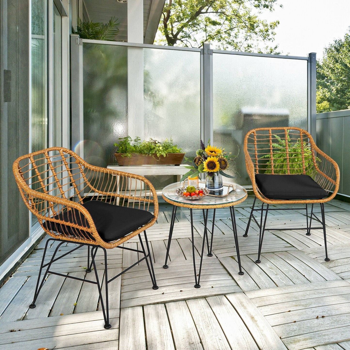 3 Pieces Rattan Furniture Set with Cushioned Chair Table-Black on a patio with glass tabletop, sunflowers, and snacks, outdoor setup