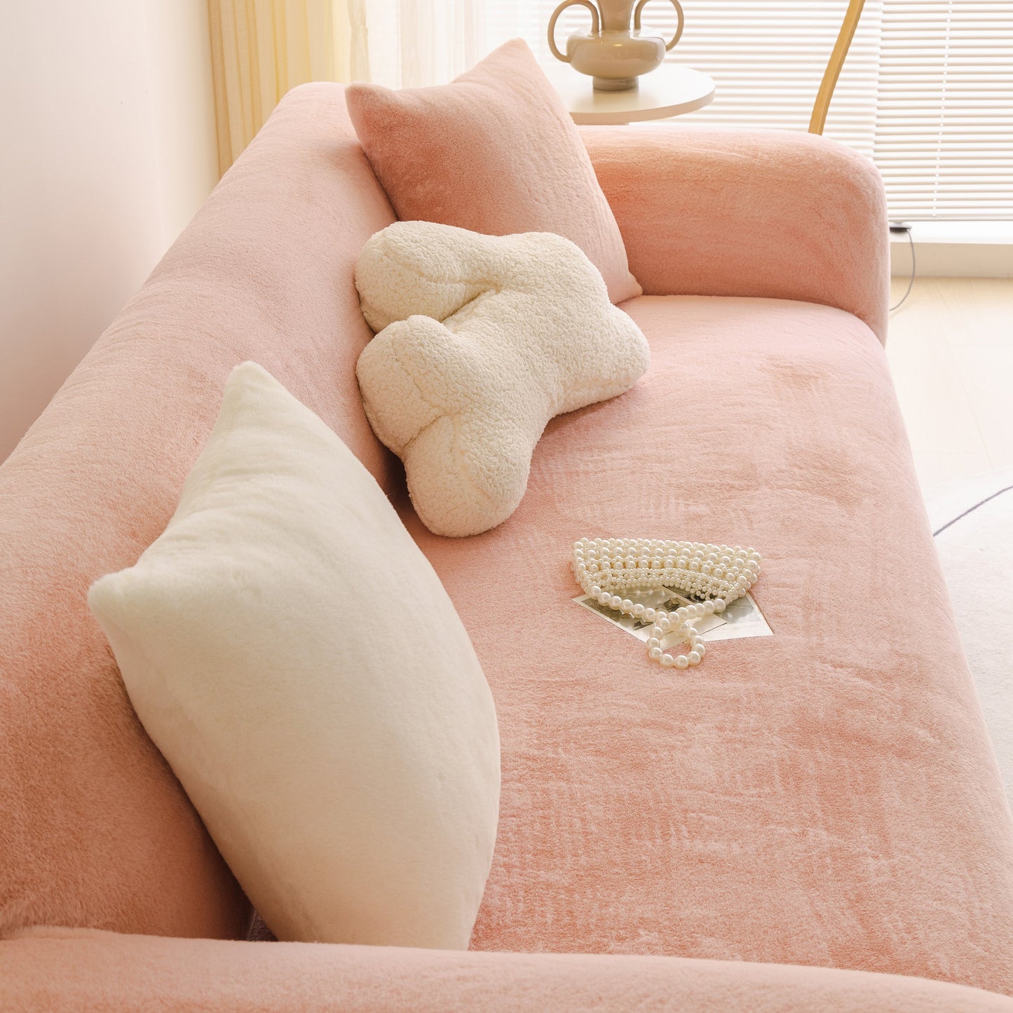 Soft Plush Warm Sofa Cover Stretchable Cozy Velvet Couch Protector for Fall & Winter on a pink sofa with pillows and decor.